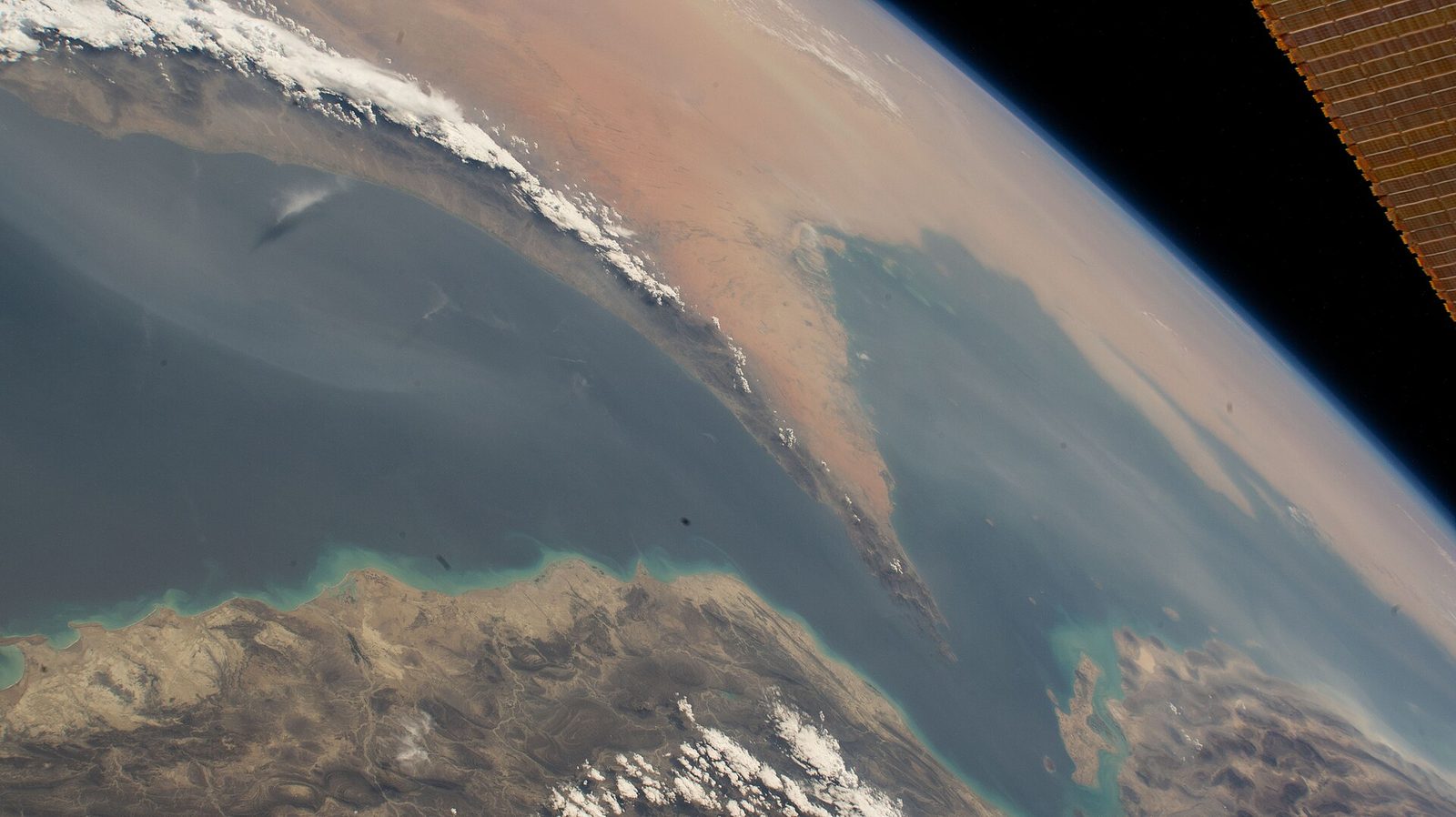 The whole problem in one photograph. The Musandam Peninsula points up at Iran; the Persian Gulf is to the left, the Gulf of Oman to the right, and everything the Gulf states sell by sea goes throug…
