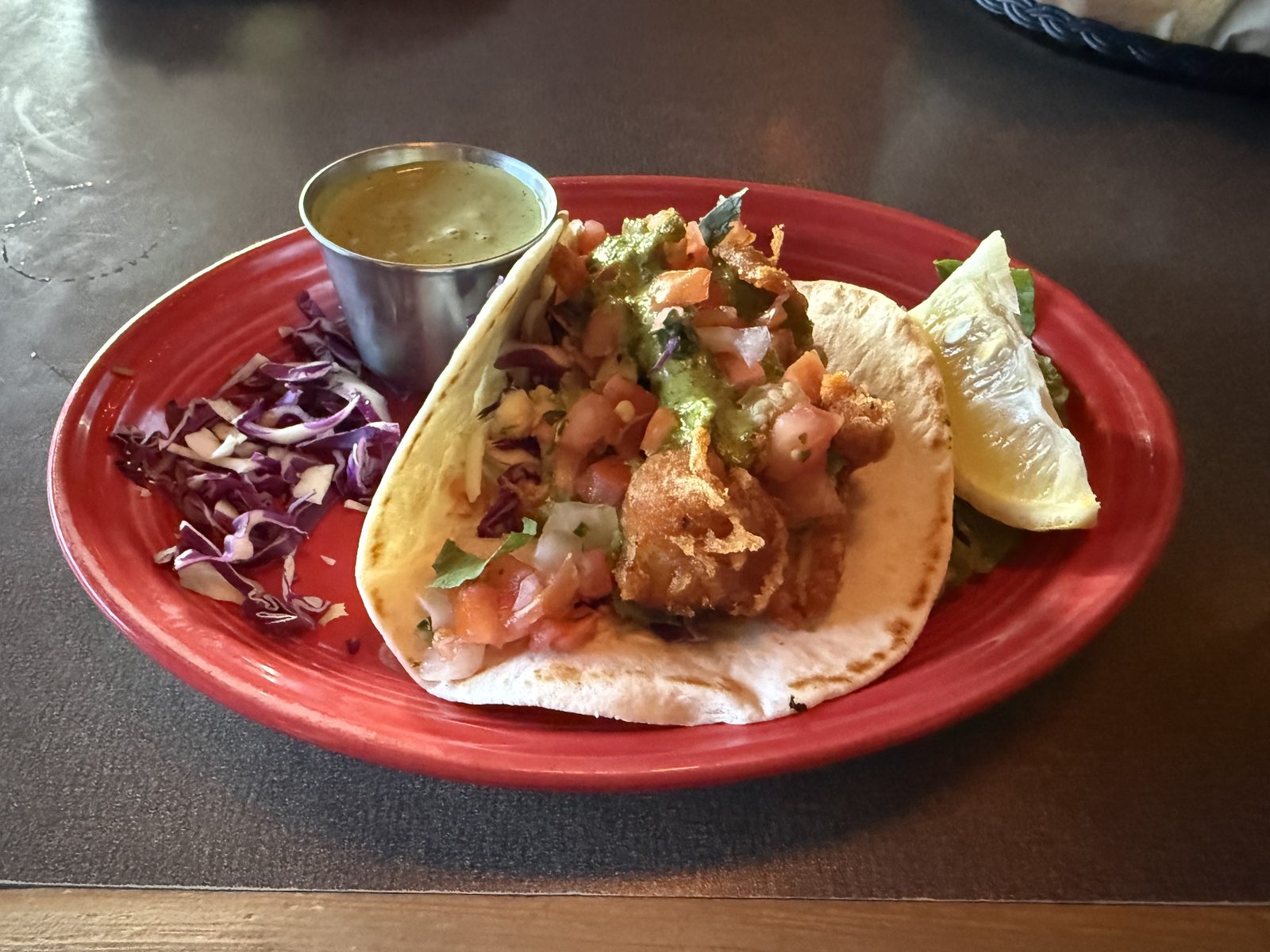 The fried fish taco. That green sauce in the cup is doing more work than a garnish usually does.