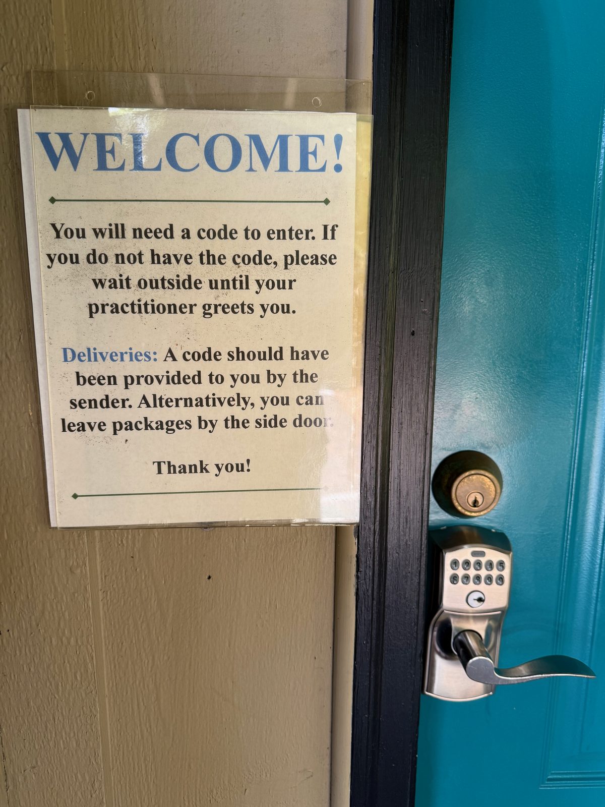 The door policy, printed and taped up — you don't wander a shared practice building unescorted.