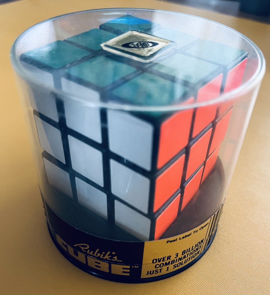The cube most American kids got that first year: made in Hungary in 1980 and sold in Ideal Toy's clear plastic canister, with no logo on the white center. Read the gold label. Photo: Racomi, Wikime…