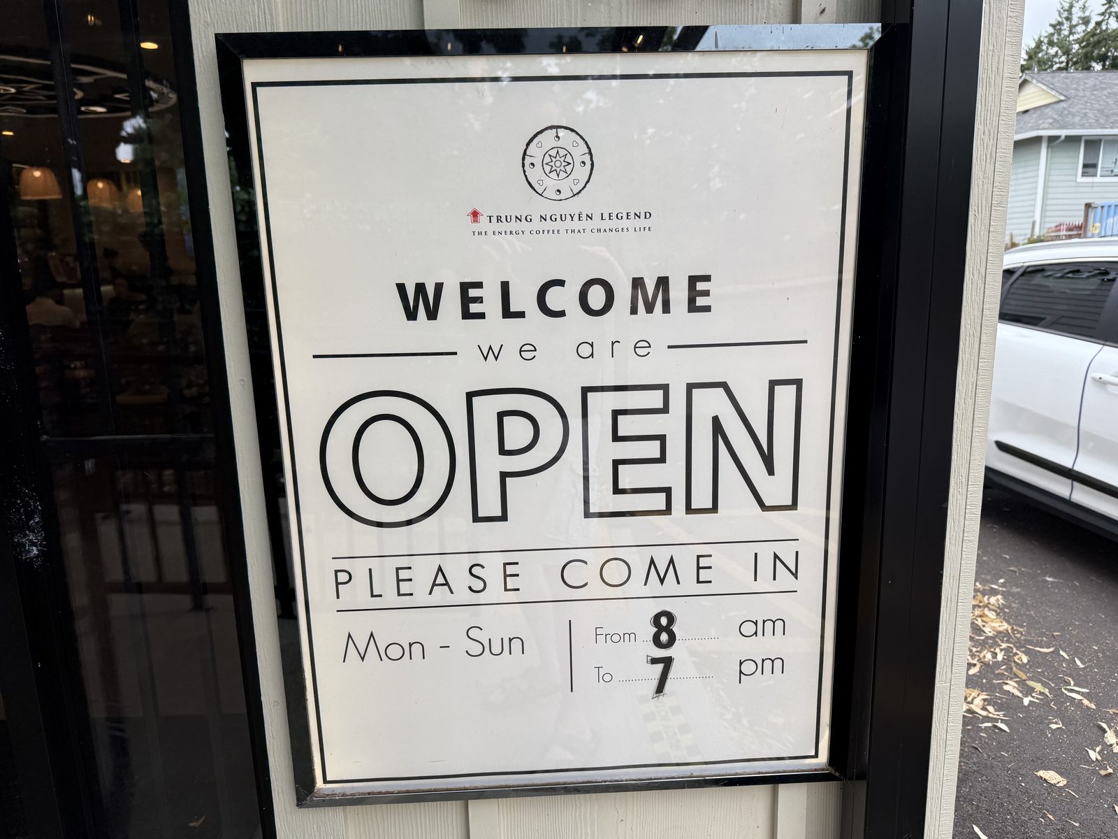 The door sign, on the way in. The tagline underneath the logo is doing more work than most café slogans bother to.