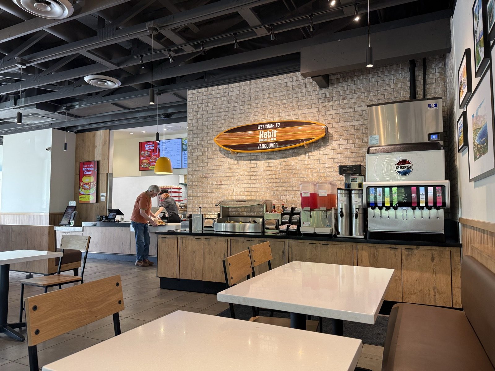 A surfboard on the wall, a long way from any water Habit Burger started next to.