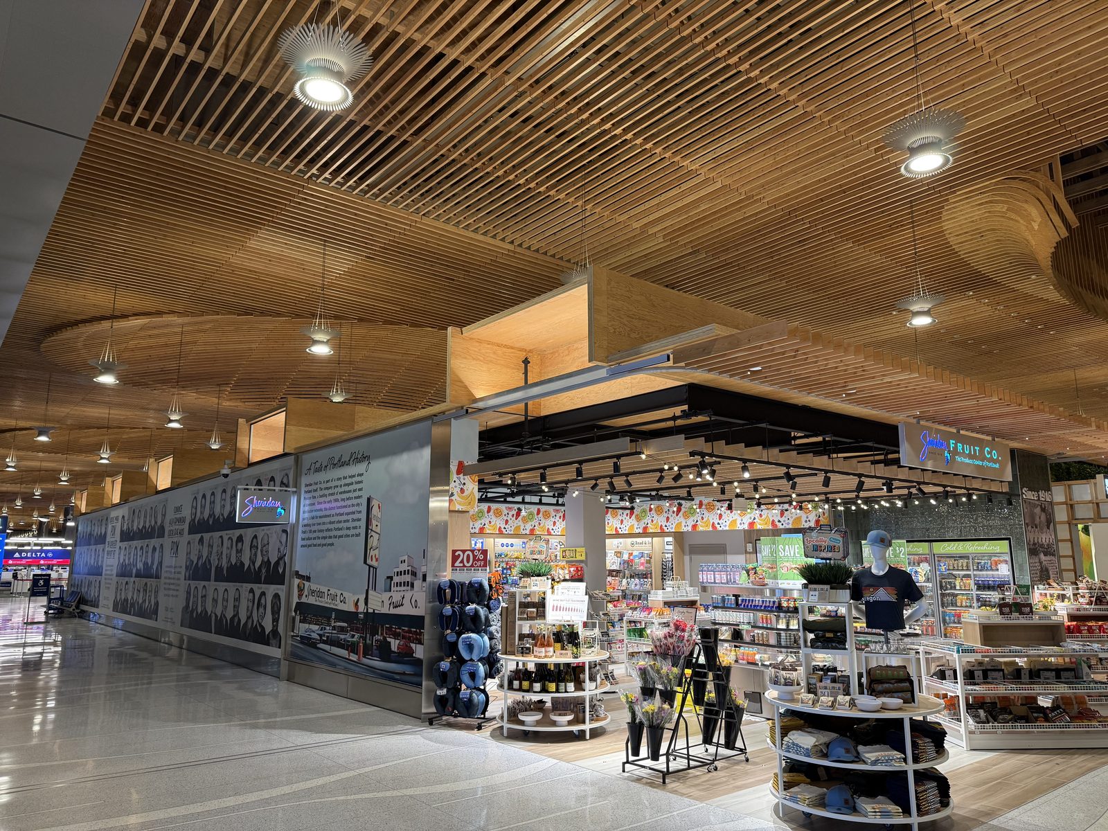 Sheridan Fruit Co.'s airport outpost, under the mural telling its own history.