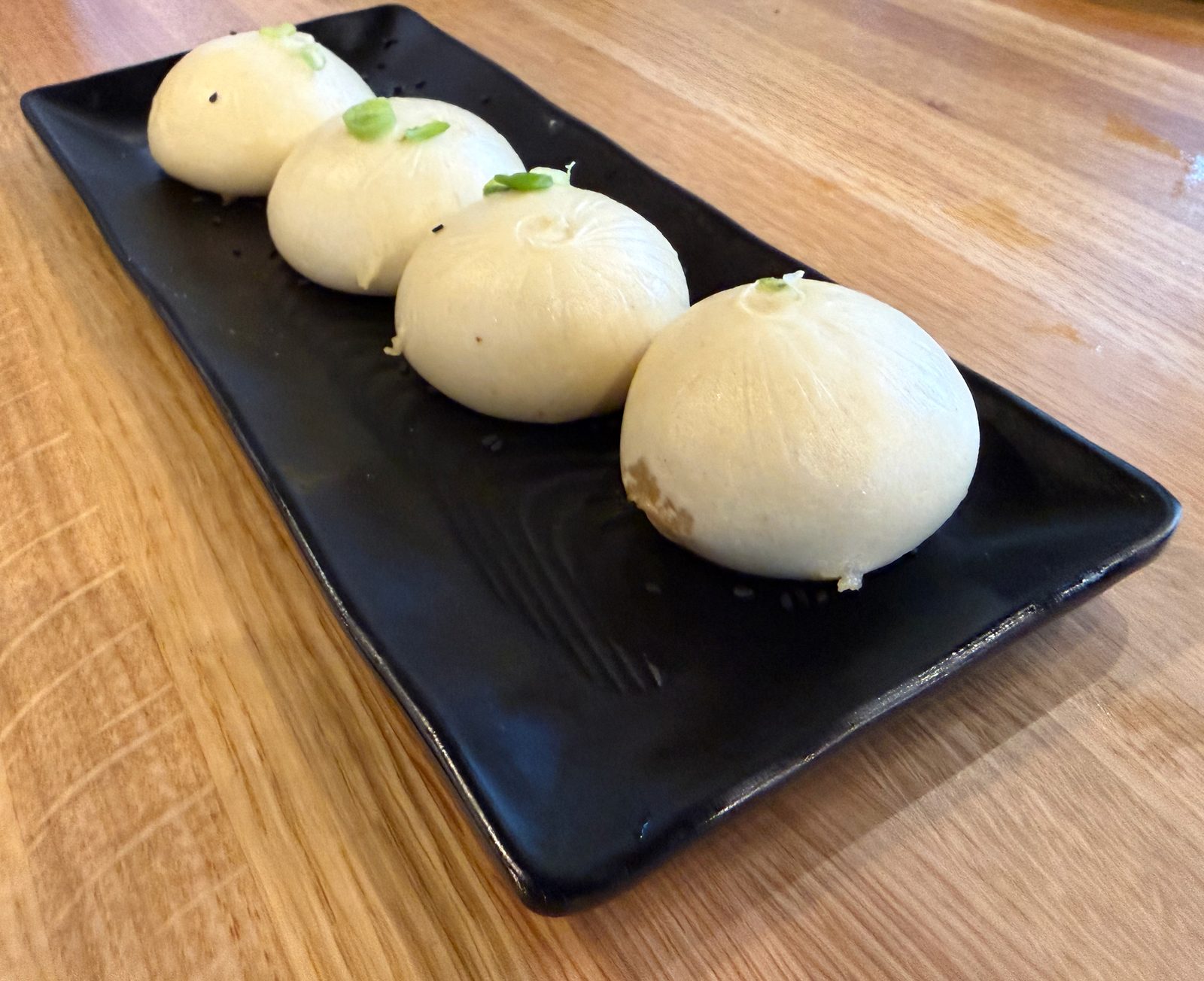 Steamed pork buns — the pillowy Q-Bao style.