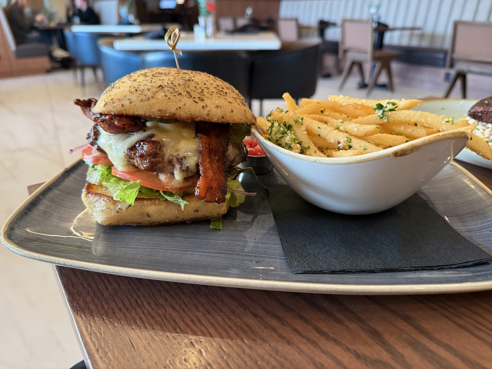The Waterfront Burger — Tillamook cheddar, bacon, and truffle-parmesan fries on the side.