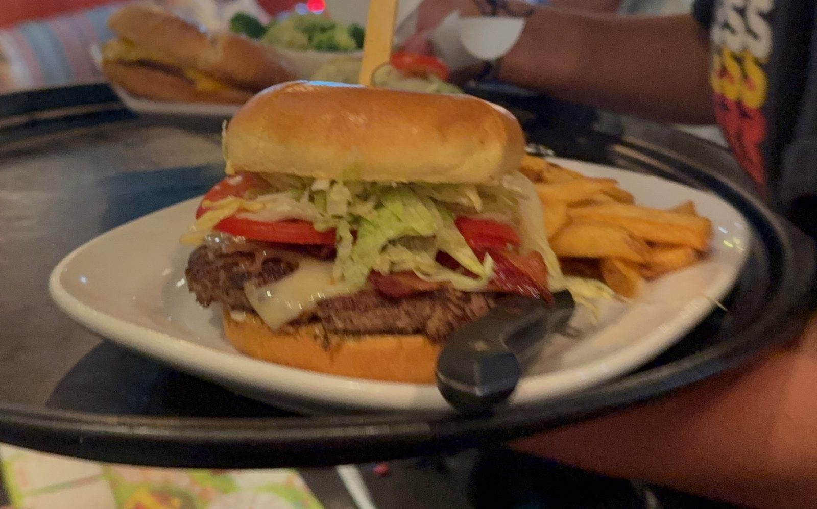 Off the tray and onto the table. The cheese is already going over the side of the patty.
