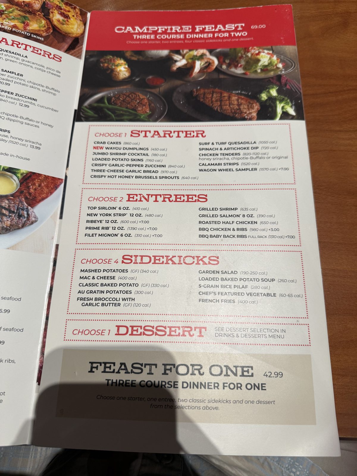 The Campfire Feast — a package for two, not what we had, but worth knowing the price of if it's your kind of night. Ribeye, prime rib and filet mignon each carry a $7 upcharge over the base entrées.