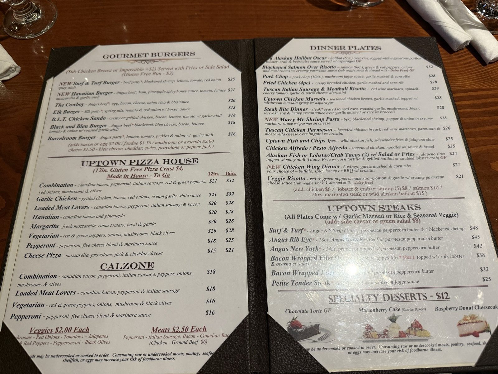 Seven burgers, $16–$25, served with fries or a salad.